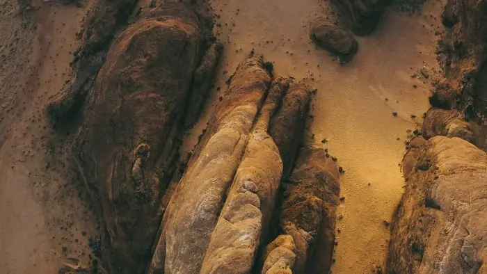 Abstract aerial desert rock formations with natural textures and sand patterns