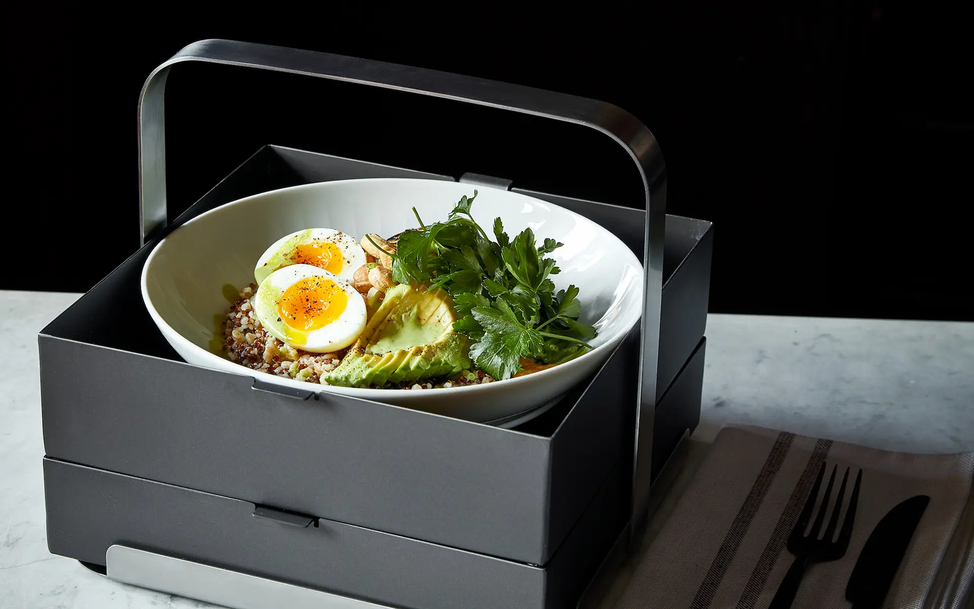 Healthy in-room dining bowl with avocado, eggs, and quinoa