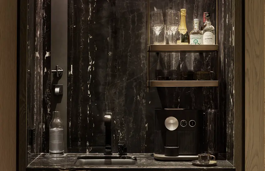 Premium in-room coffee and minibar setup with marble interiors