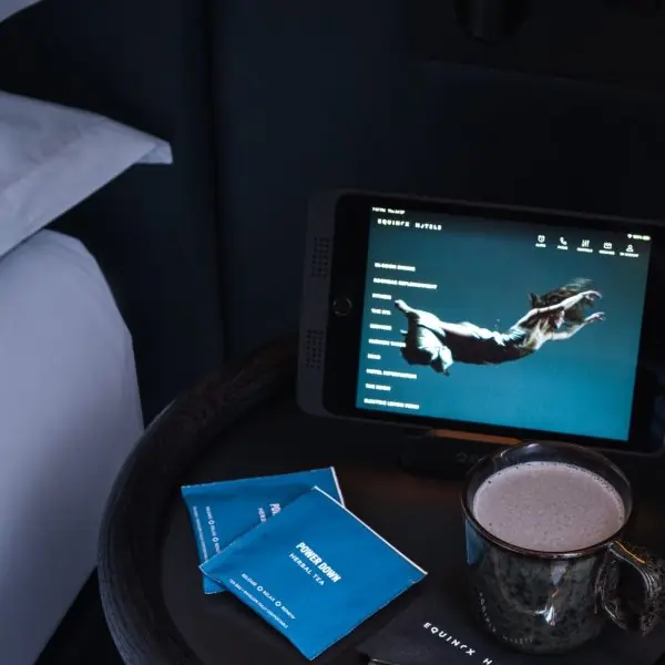 In-room wellness setup with herbal tea and digital content hub