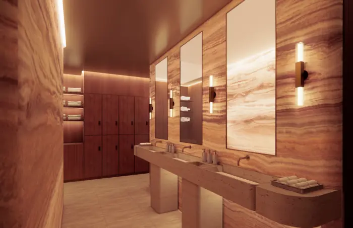 Luxury spa locker room with marble vanities and warm lighting