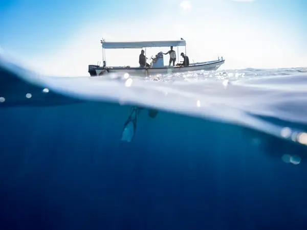 Boat floating above crystal clear Red Sea waters