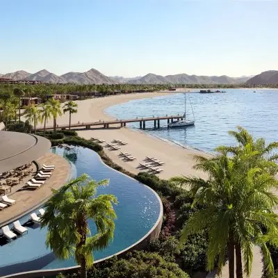 Aerial beachfront view with infinity pool and marina at Amaala