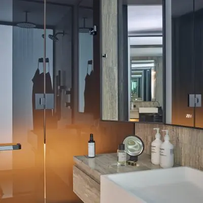 Luxury hotel bathroom with glass shower and stone vanity