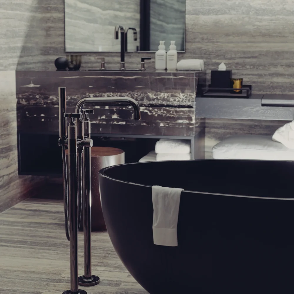 Luxurious bathroom with matte black tub, striped stone walls, and marble vanity, evoking spa-like serenity and modern indulgence