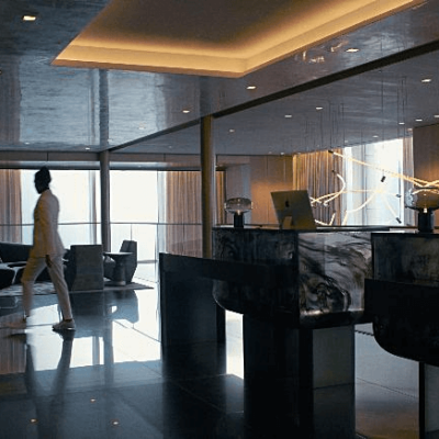 Upscale reception area with marble desks, glossy floors, and warm lighting—modern elegance meets functionality.