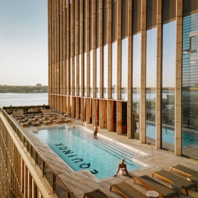 Scenic rooftop pool at Equinox Hotel NYC with city views, luxury loungers, and guests enjoying the upscale ambiance.