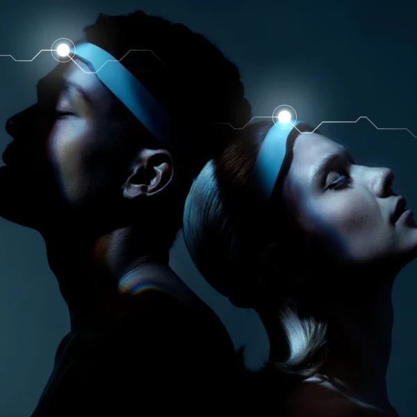 Two people standing back-to-back in dark blue-lit setting, glowing forehead lights with neural graphic above suggesting mental synchronization
