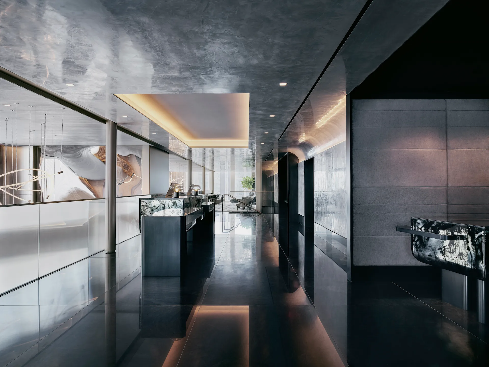 High-end lobby with reflective black floors, metallic ceiling, and marbled counters, evoking sleek luxury and architectural depth