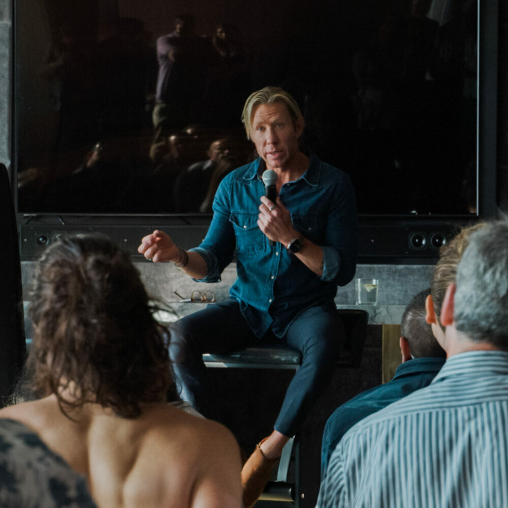 Dr. Matthew Walker leading a chronotype session, speaking to an engaged audience about sleep science.