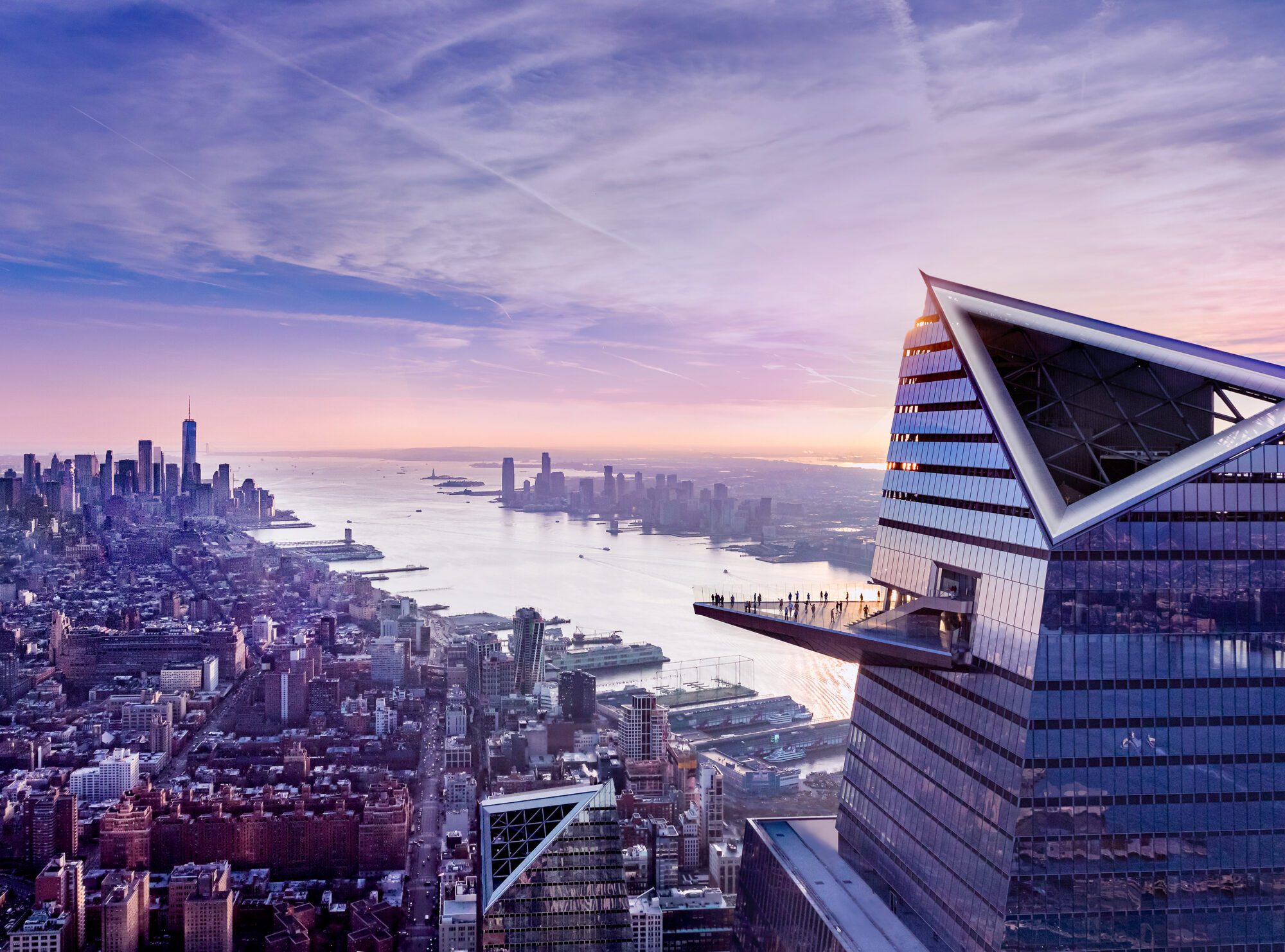 Aerial view of Edge observation deck jutting from skyscraper at sunset, overlooking Manhattan skyline and Hudson River