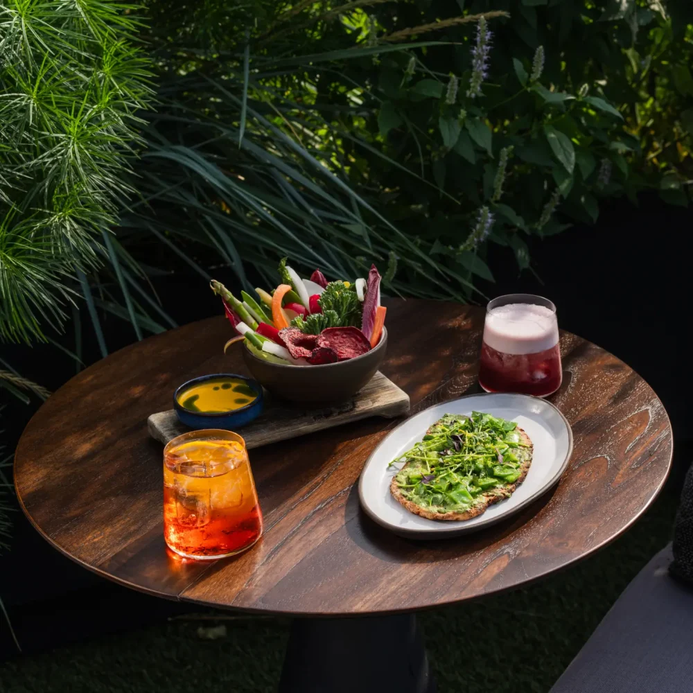 EquinoxHotel JoeThomas 30 2 Colorful cocktails and fresh dishes on an outdoor table