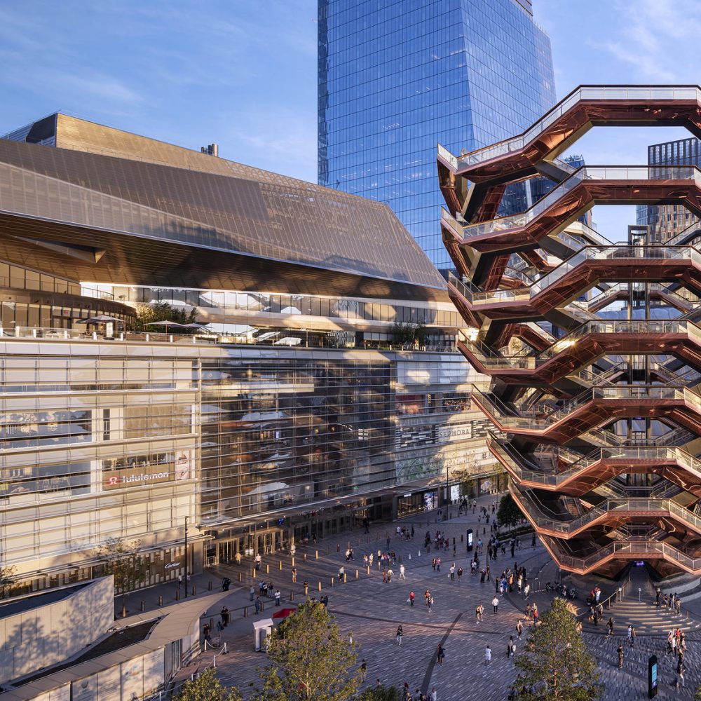 The Vessel at Hudson Yards in New York City with surrounding modern architecture, public plaza, and visitors below