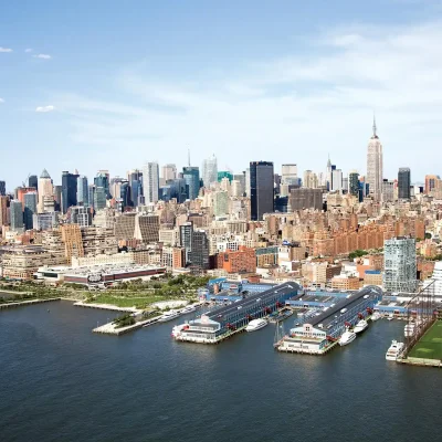 Aerial view of Manhattan skyline with Empire State Building, Hudson River, and waterfront piers