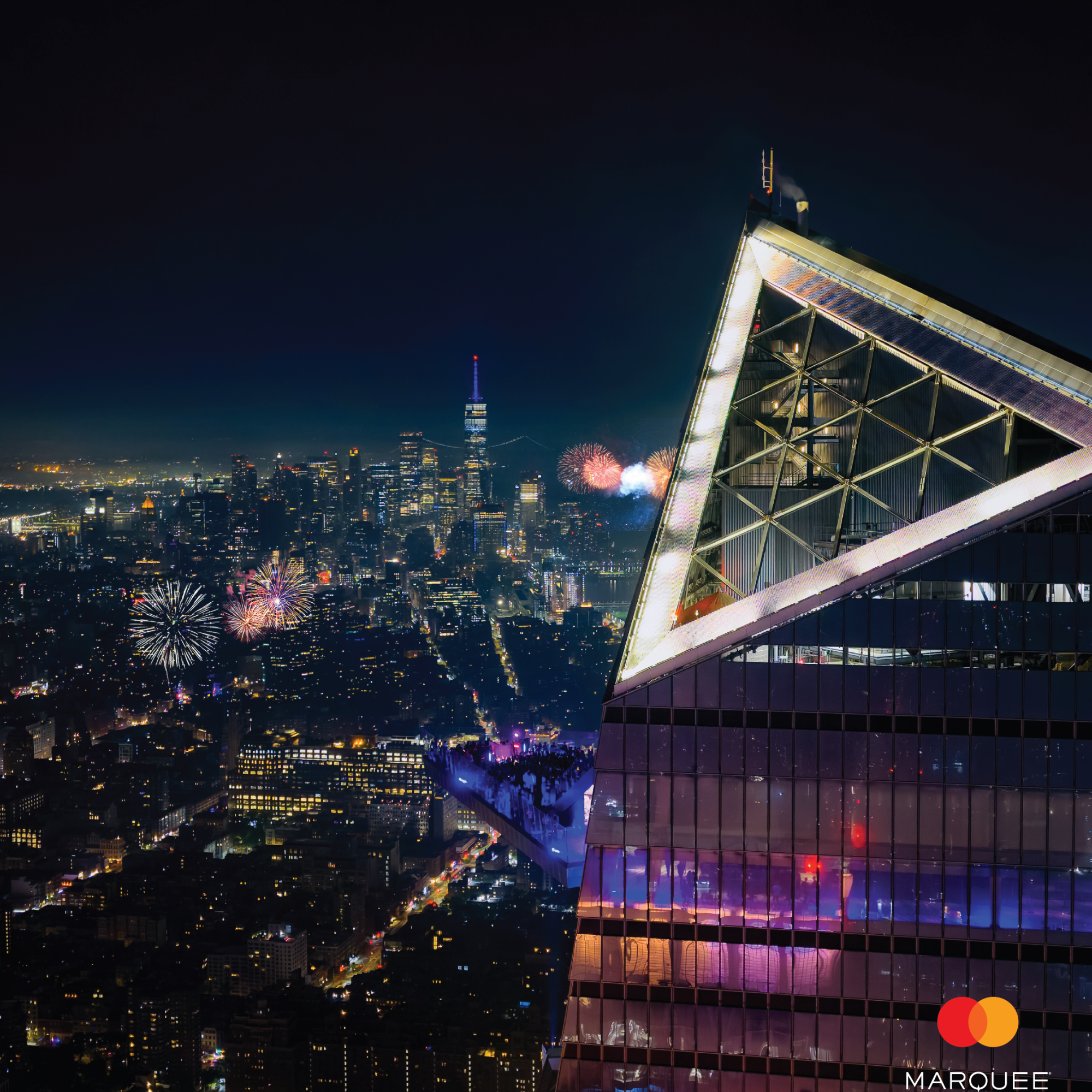 Fireworks over the NYC skyline viewed from Edge’s glass sky deck at night