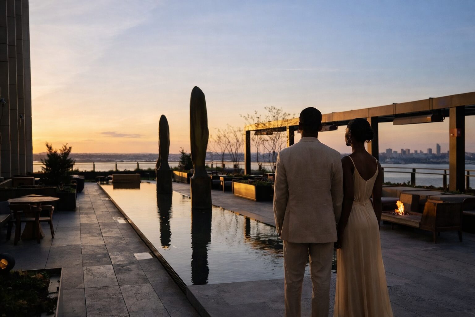 Silhouetted couple on Equinox rooftop terrace overlooking NYC at sunset
