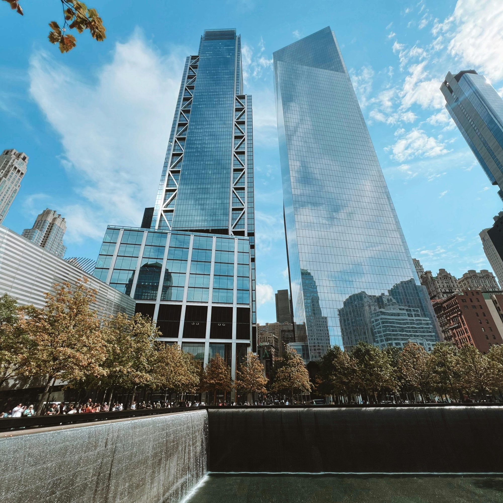 9/11 Memorial reflecting pool with surrounding skyline and One World Trade Center in Lower Manhattan, New York City