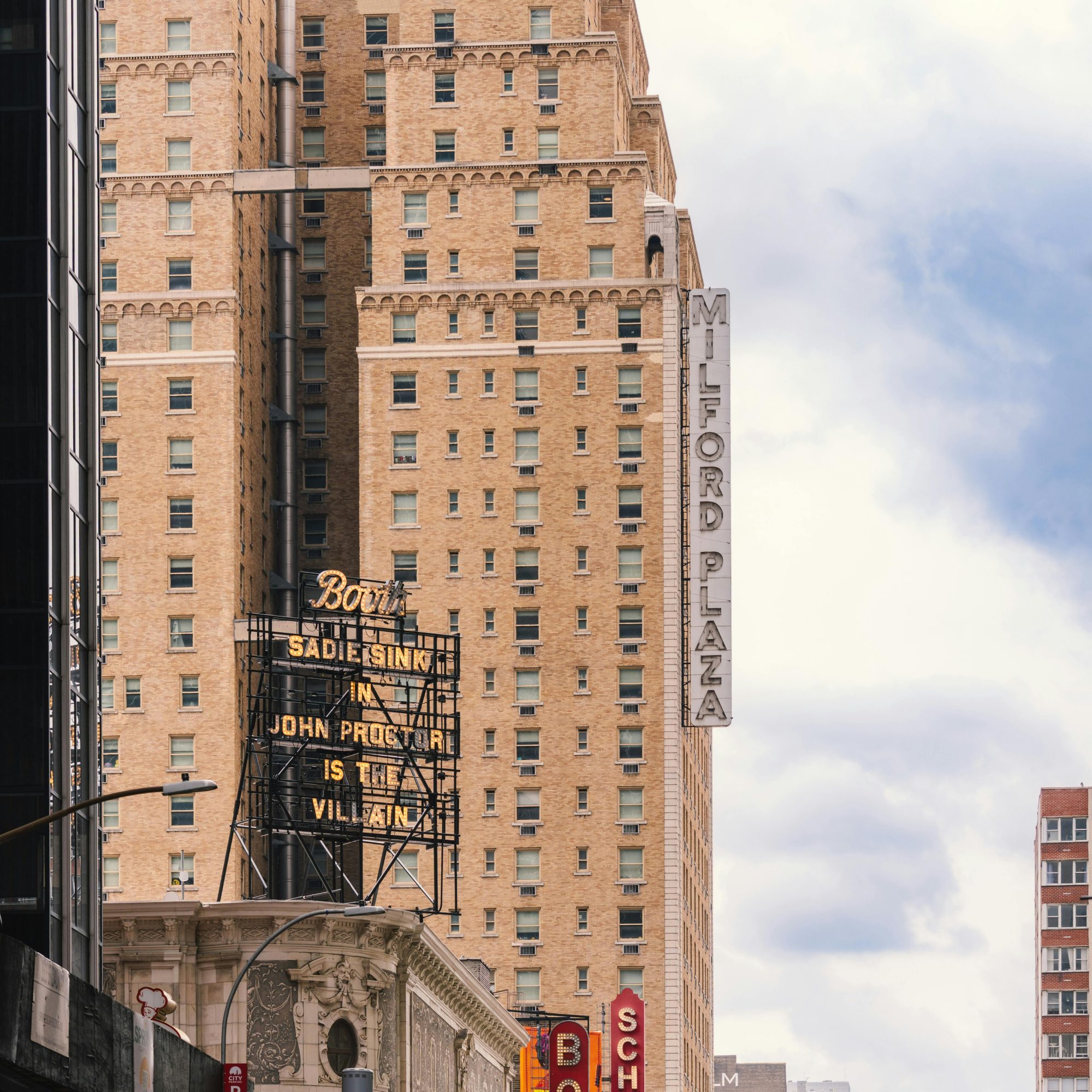 Broadway theater signage along Midtown Manhattan with Booth Theatre and Schoenfeld Theatre marquees against classic NYC architecture