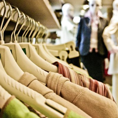 Close-up of garments on wooden hangers inside a SoHo boutique