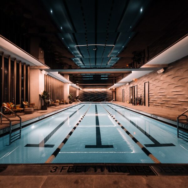 Elegant indoor lap pool with soft lighting, sleek design, and tranquil atmosphere.