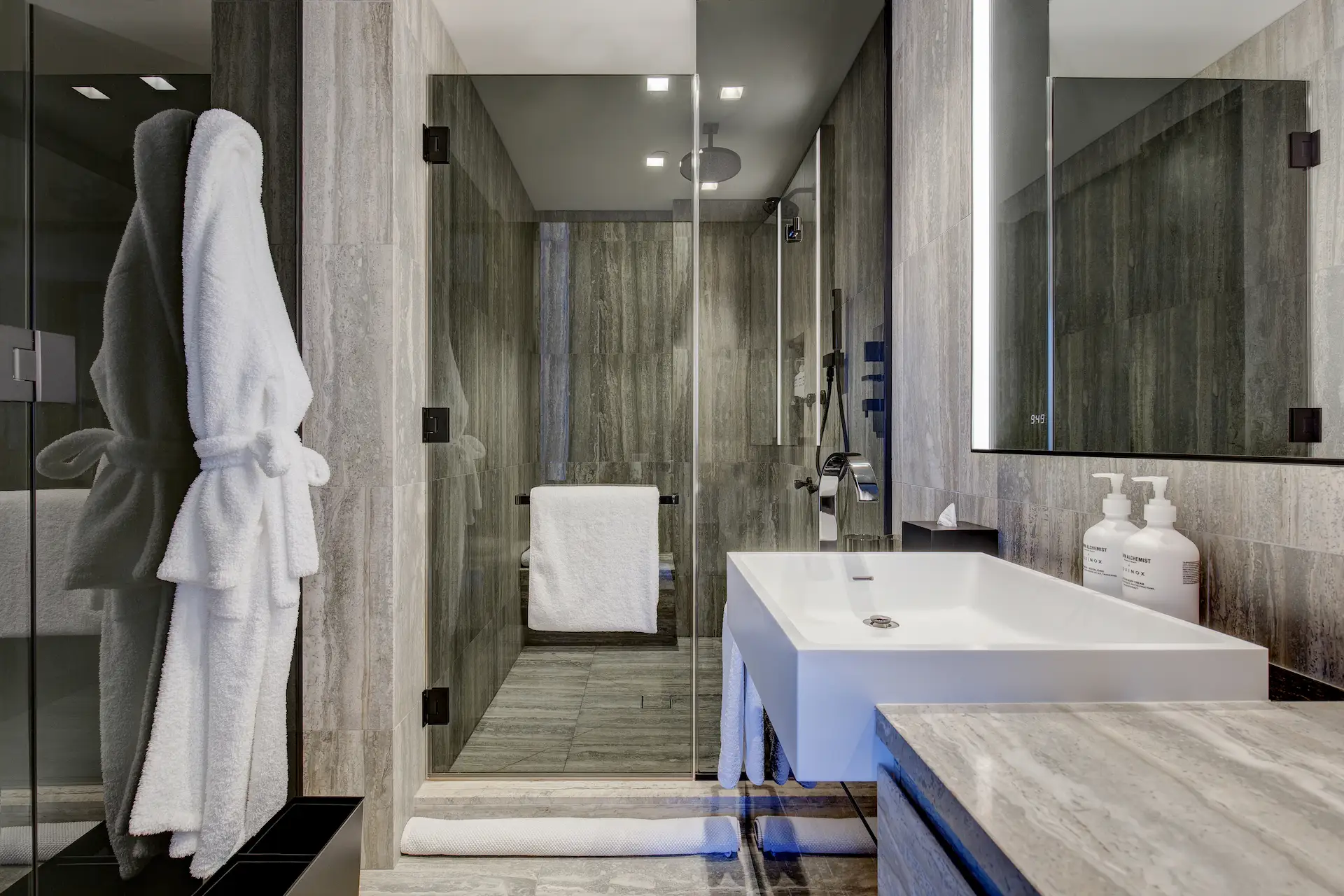 Spacious, light-filled bathroom with hanging robe and large walk-in shower.