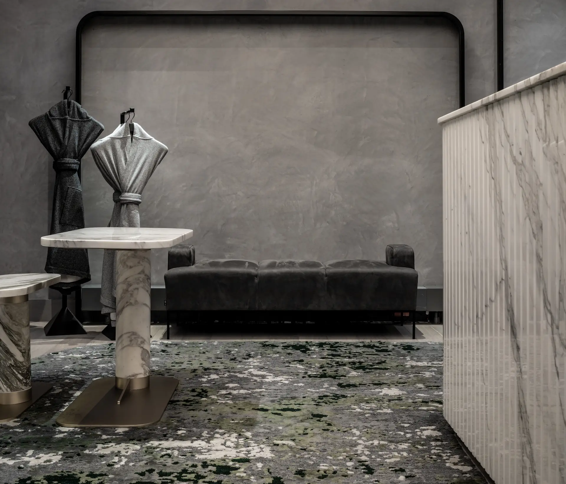 Modern lounge space with minimalist sofa, marble tables, and sculptural coat stands at Equinox Hotel