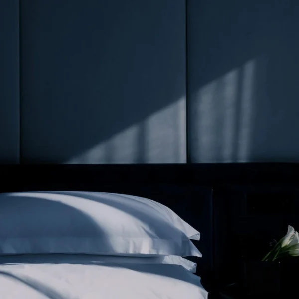 Equinox Hotel room, perfectly prepared for restorative sleep, soft lighting, plush bedding, and calming design.