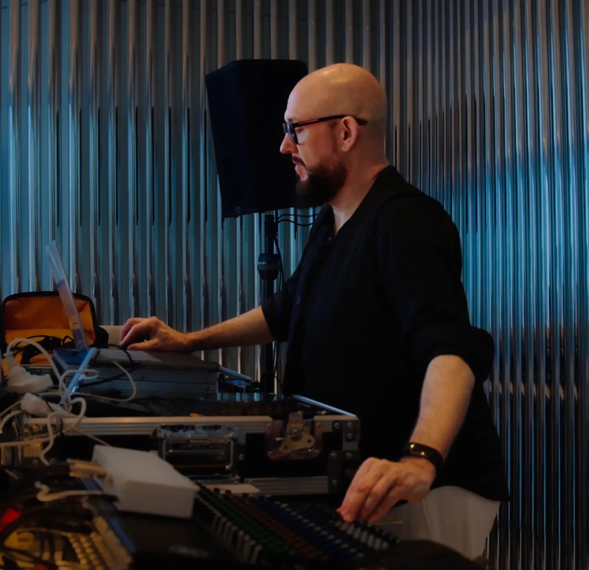Tom Middleton mixing sound during wellness event, combining music and sleep science in modern indoor setting