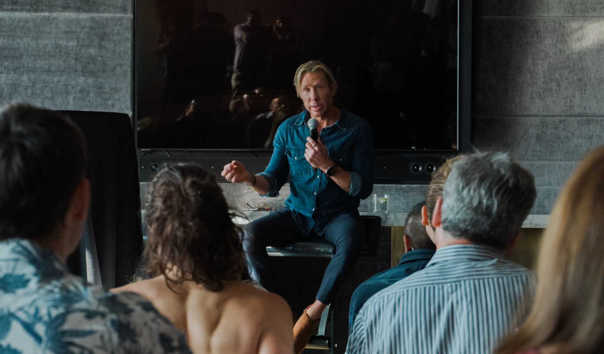 Dr. Matthew Walker speaking to audience about sleep science in modern indoor setting