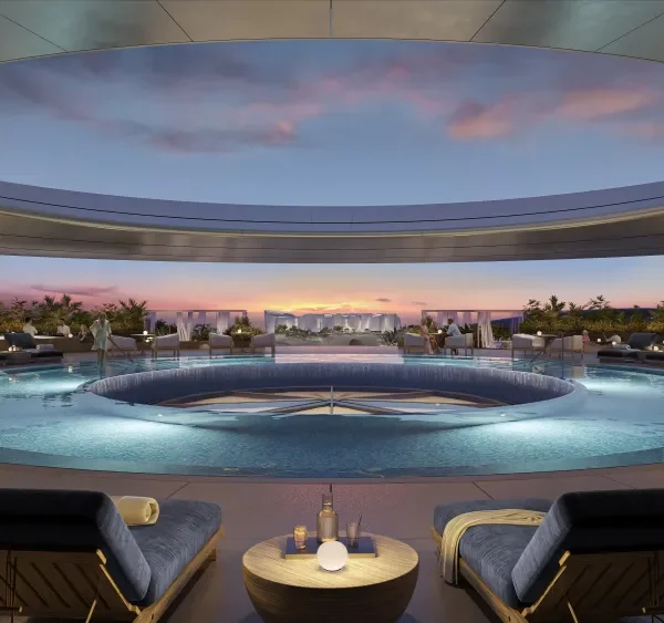 Circular rooftop pool framed by an open ring, sunset skyline view, lounges and cabanas surrounding.