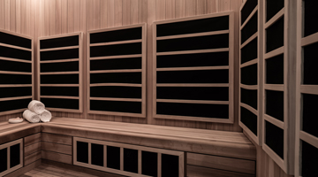 Wooden sauna room with light paneling, black heater panels, corner bench, and a stack of rolled towels.